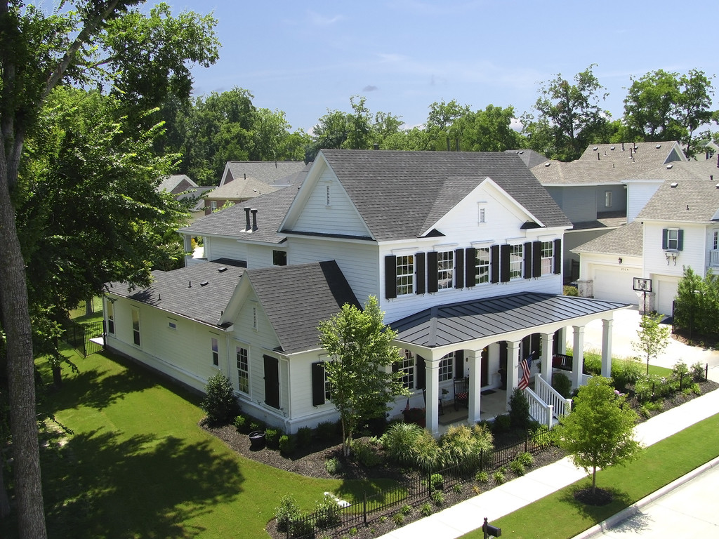 Cheltenham House aerial — Southern Colonial footprint, standing seam metal porch roof, mature tree canopy