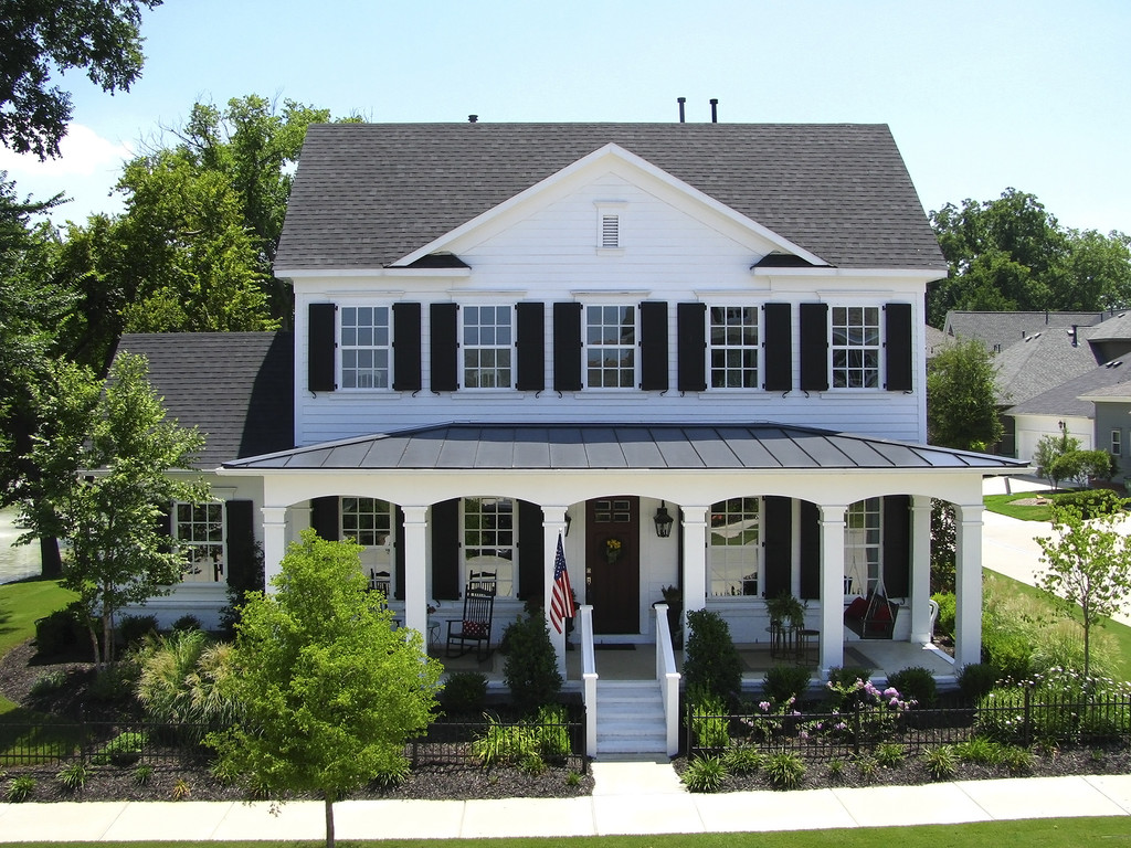 Cheltenham House — Southern Colonial exterior, wrap-around porch, standing seam metal roof, black shutters