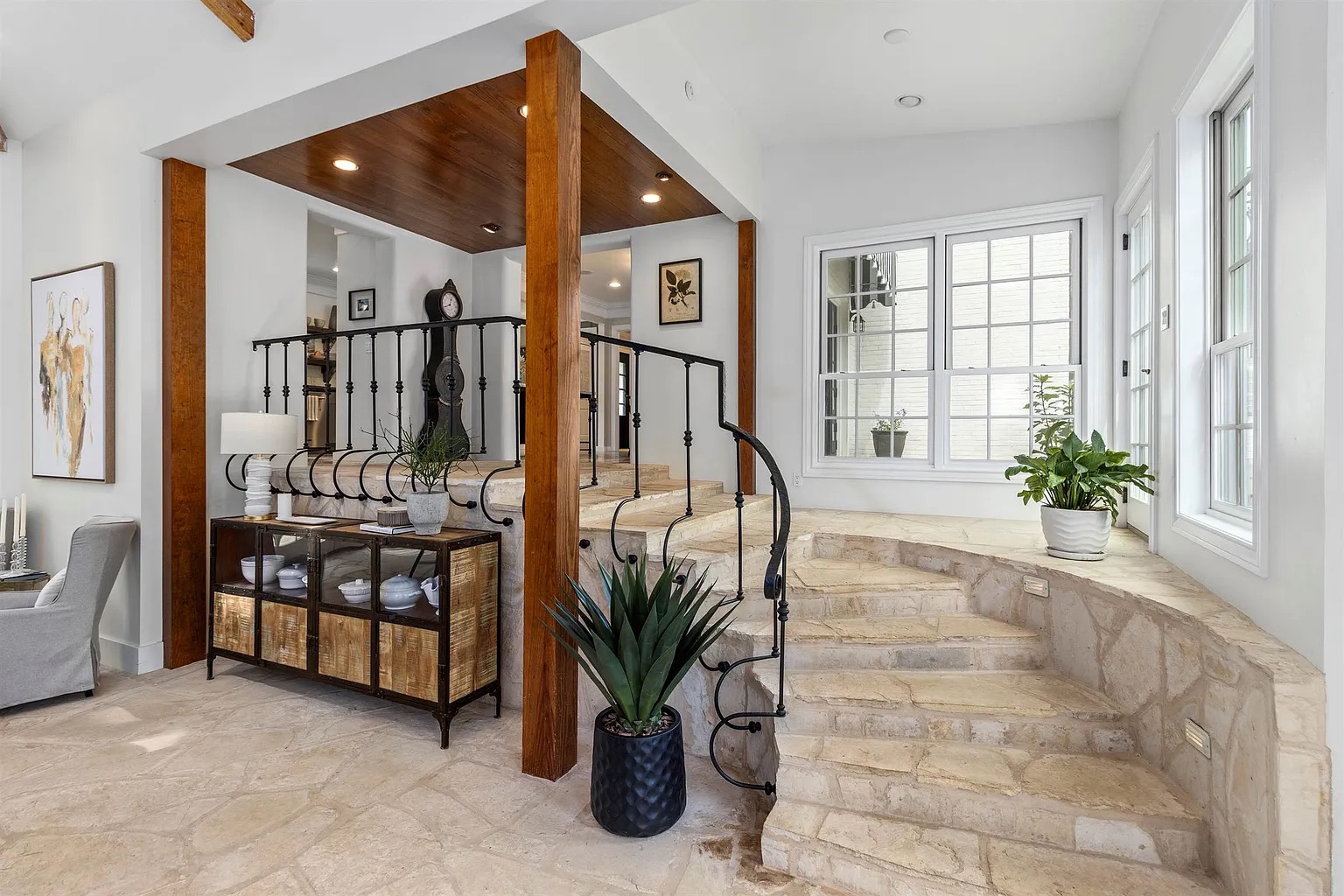 Tyler Estate spiral stair — wrought iron spiral staircase with stone treads, timber column, cedar ceiling, large windows